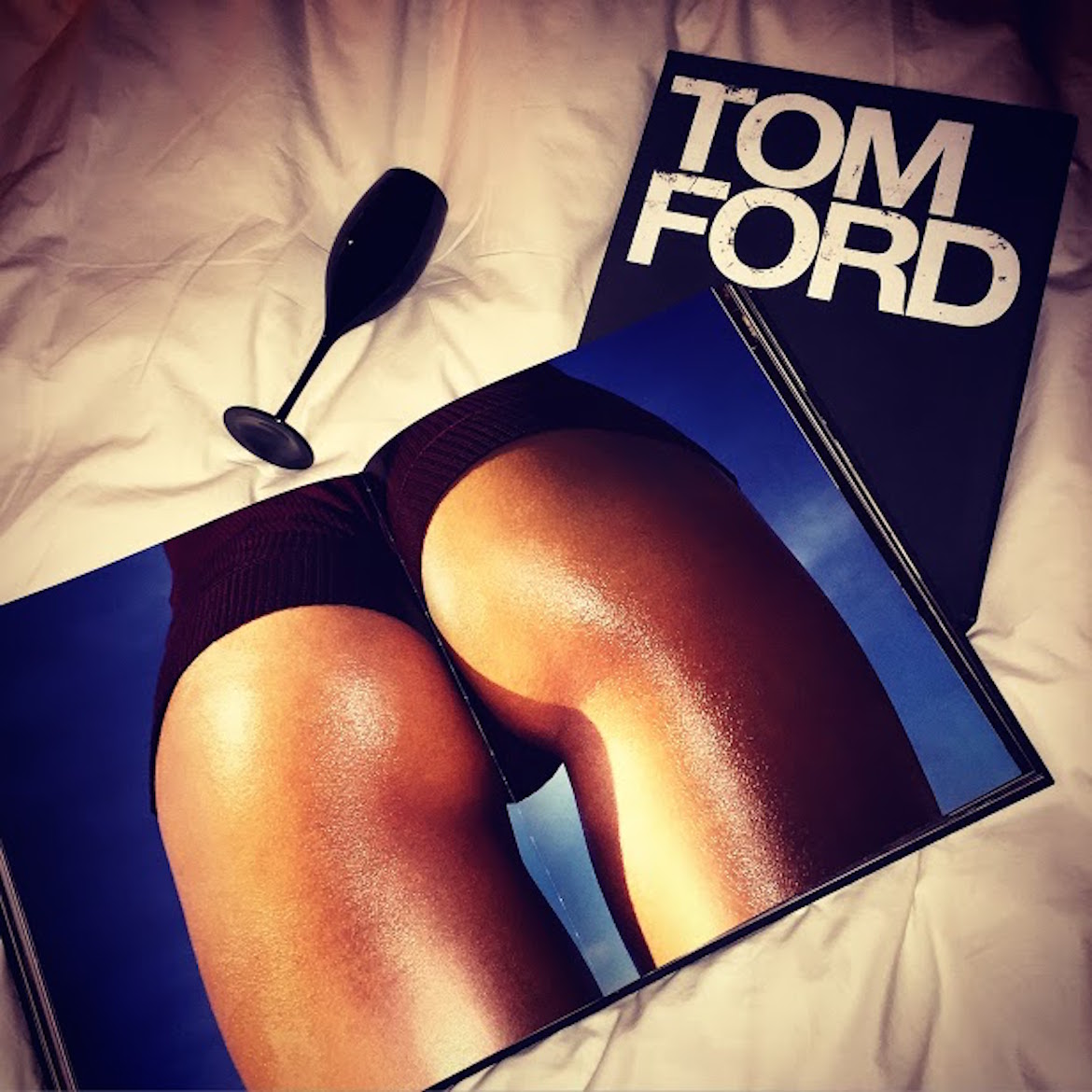 Studying Tom Ford history in bed with a glass of champagne...