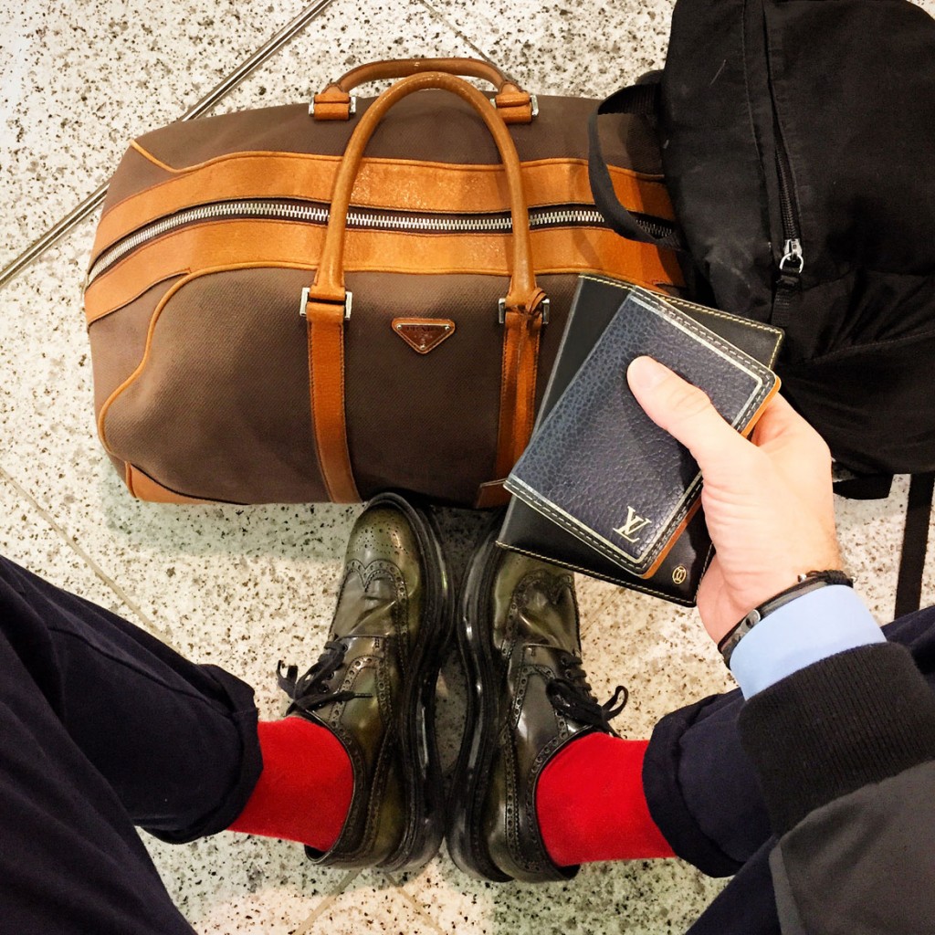 On the way back home... Weekend bag, backpack, shoes & shirt by Prada, trousers & bomber jacket by COS, card-holder by Louis Vuitton, passport leather case by Cartier