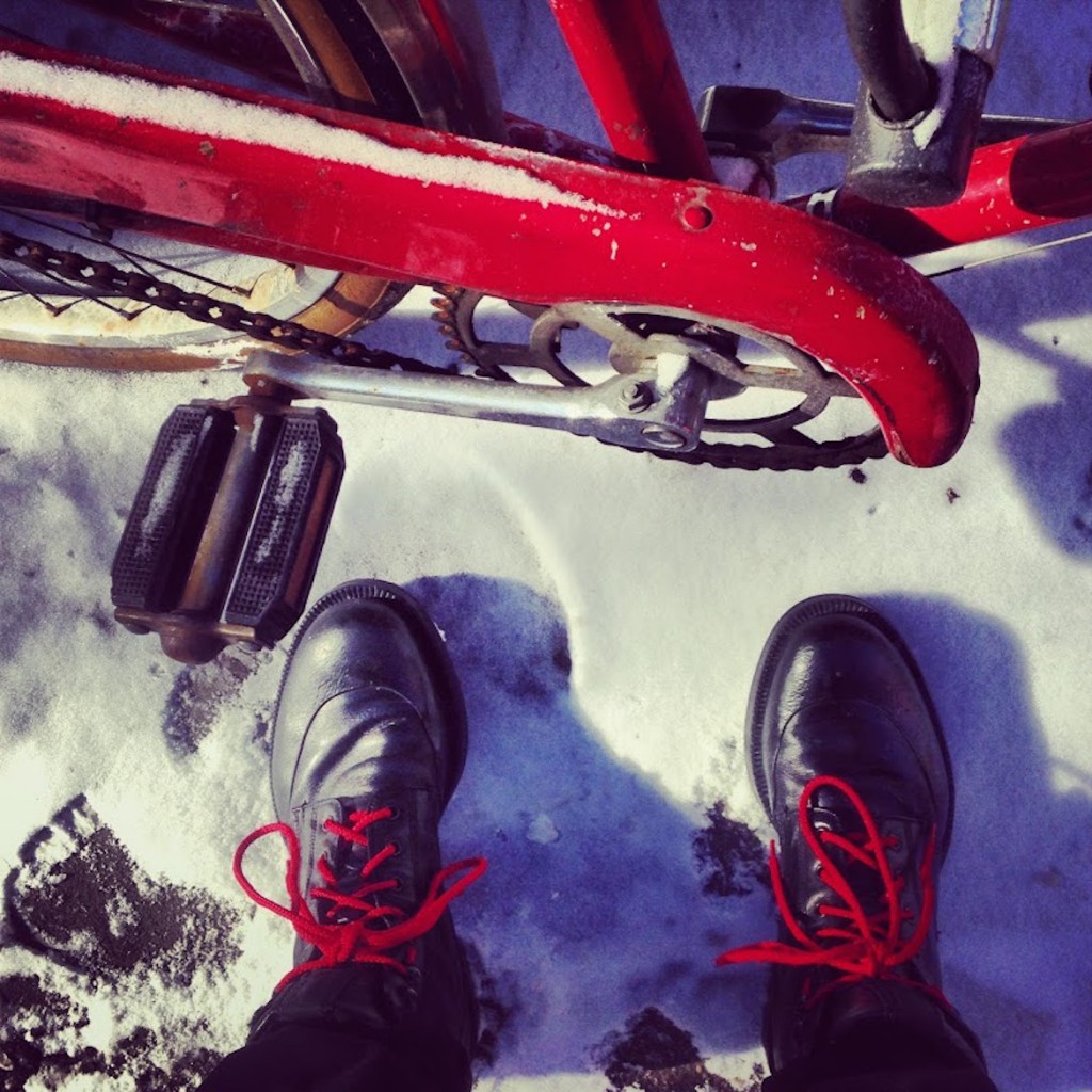 Use the bicycle to move around Manhattan -here at Bleecker Street wearing Prada boots.