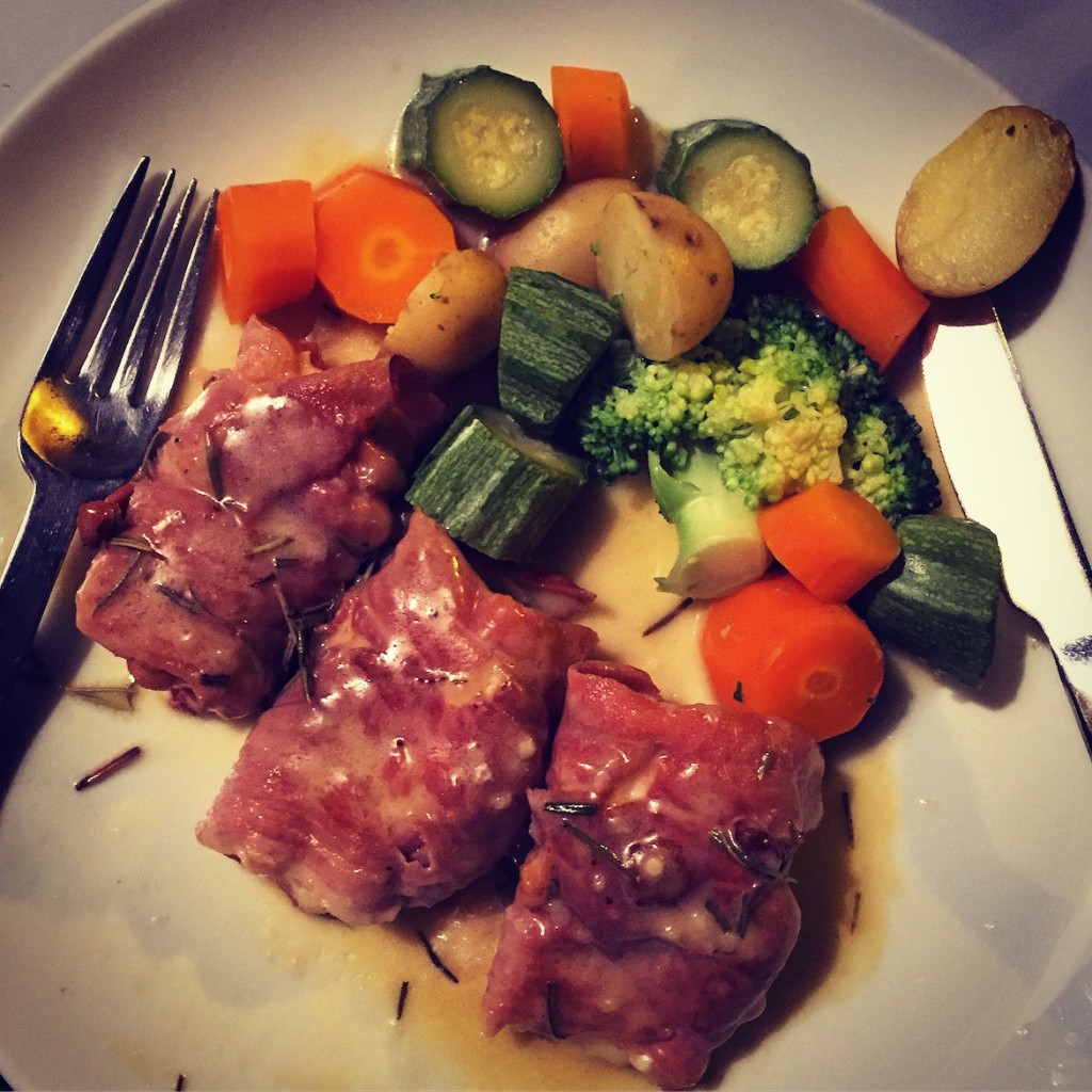 Colorful dish of chicken wrapped in prosciutto di parma & mozzarella di bufala.