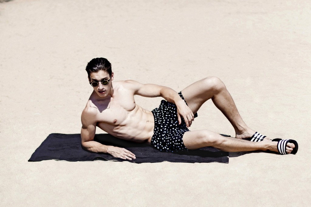 Swim-shorts by Theory & beach towel by Alexander Wang (all SOHO-SOHO). Sunglasses by Mykita x Damir Doma. Slides by Adidas.