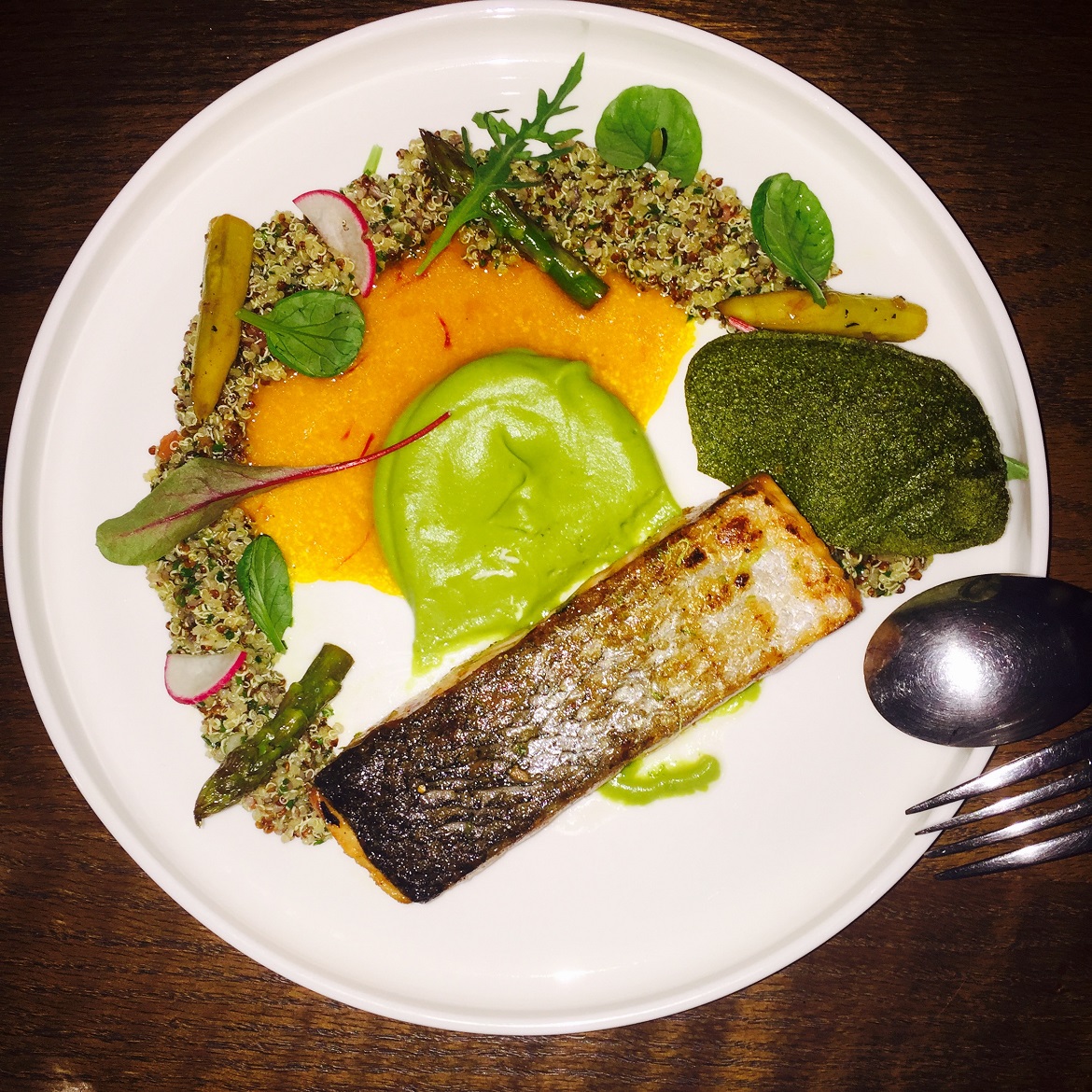 Grilled salmon with asparagus, greenpea puree & saffron flavored sauce.