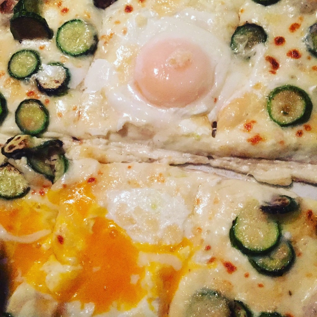 Pizza Rossini with sunny side up eggs plus delicious greek zucchini
