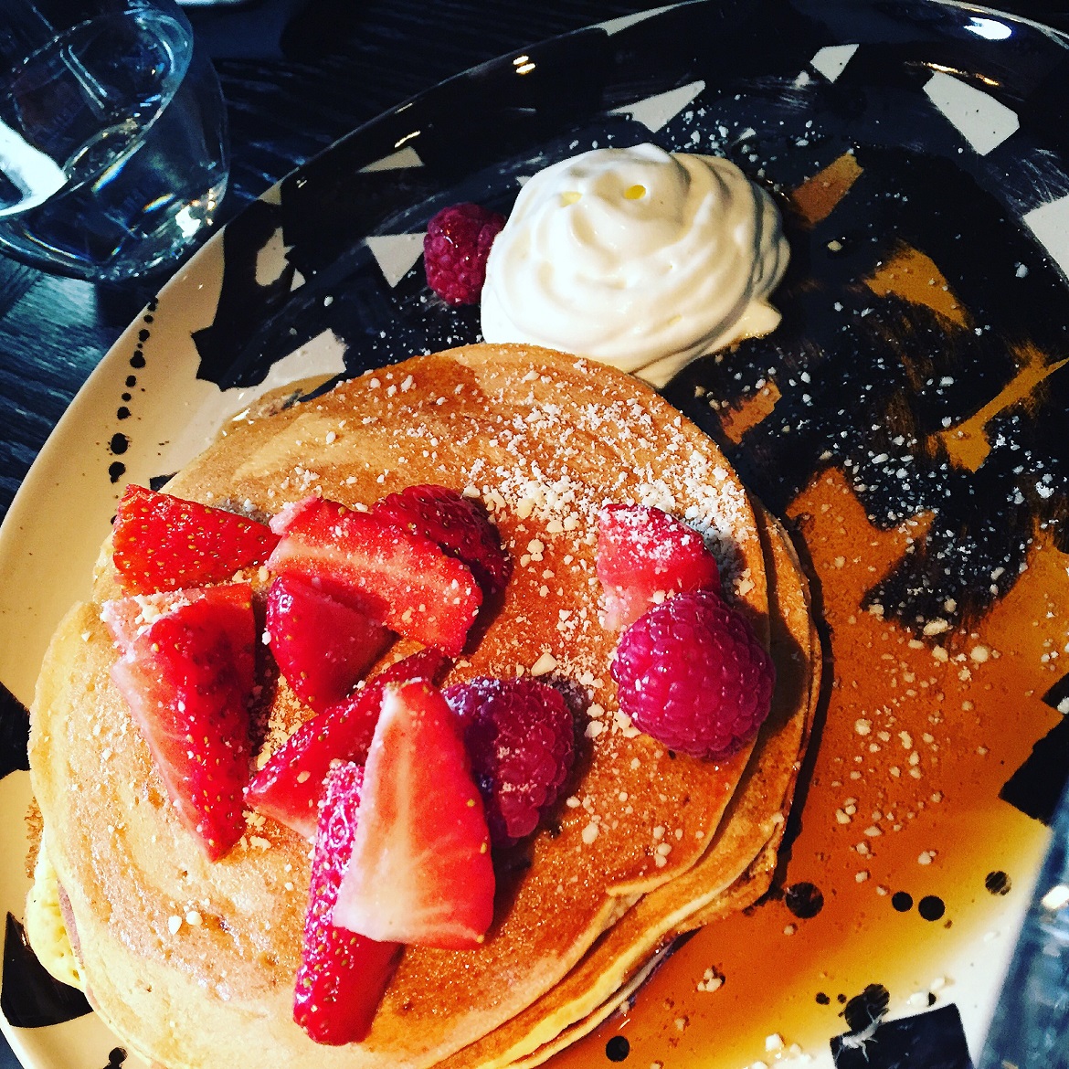 With maple syrup, red fruits & whipped cream at MALCONI'S
