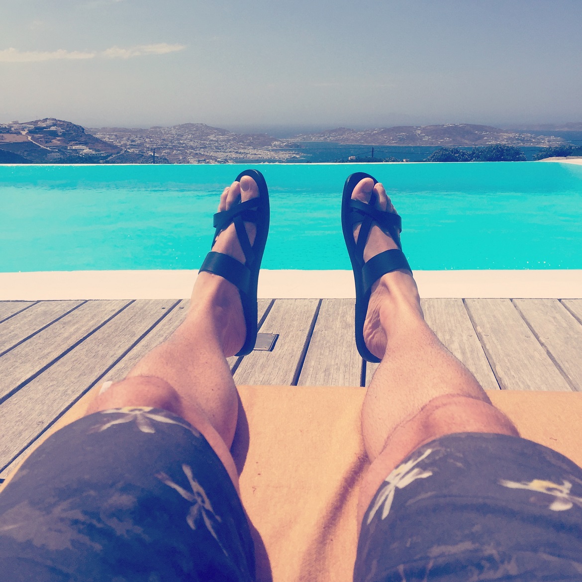Ηappy feet in Jason sandals overlooking the beautiful town of Mykonos // shorts by The Project Garments
