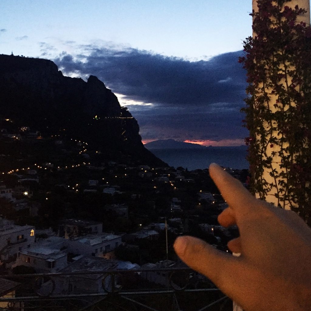 The sun sets behind Vesuvius (still active) volcano...